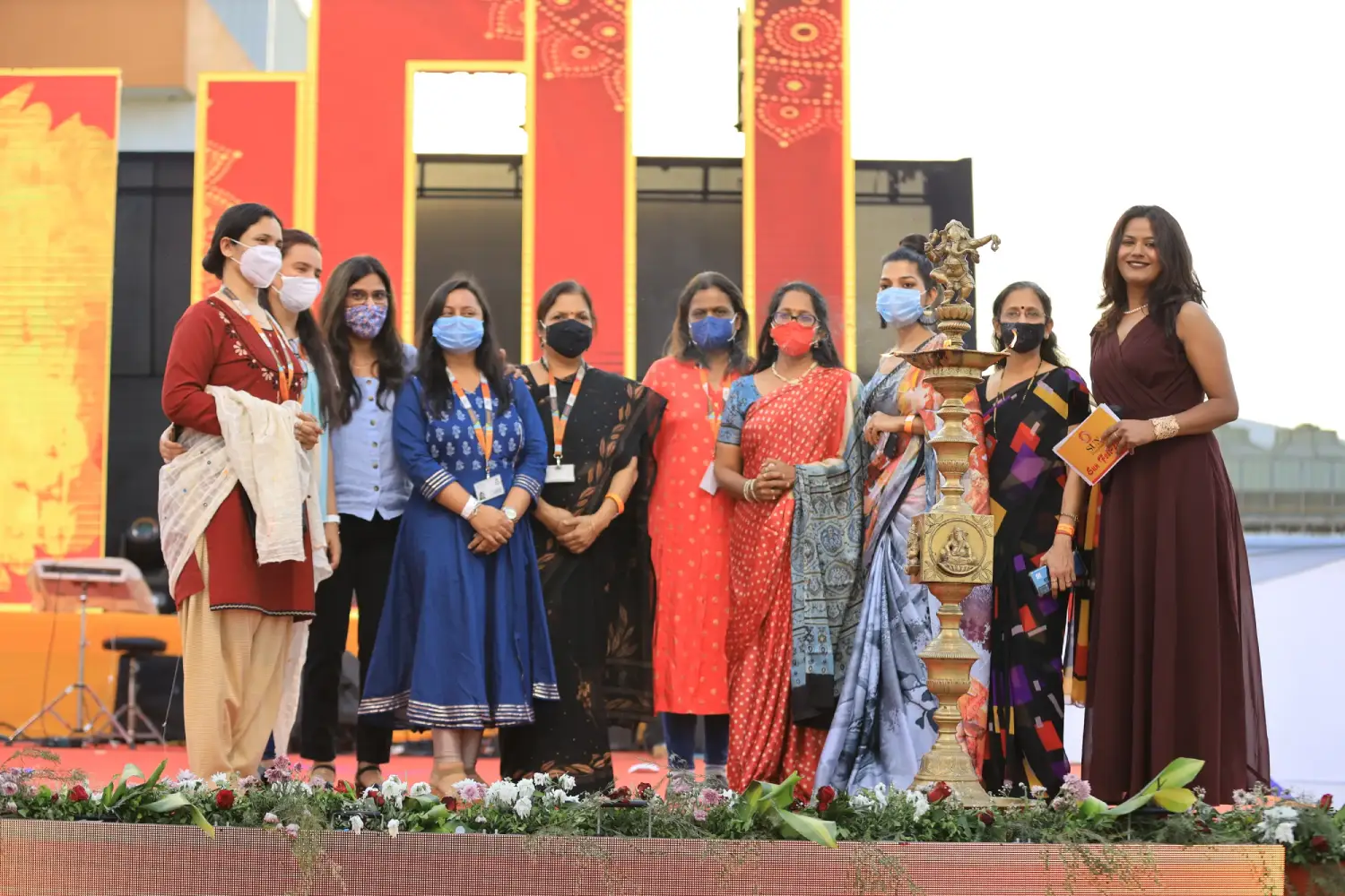 ITT event entrance with red and green carpet and pink lighting on white structure with ITT branding